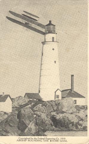 plane flys by lighthouse