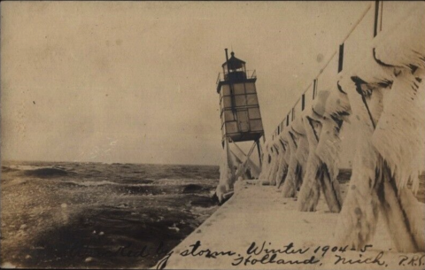 winter storm and lighthouse leans toward water