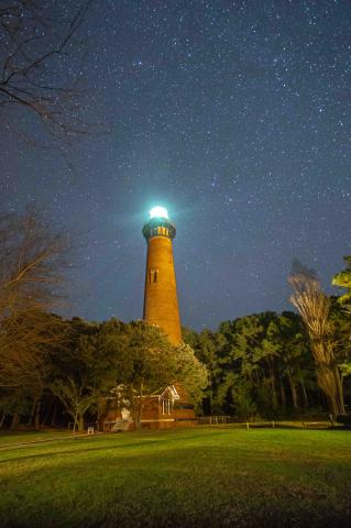 lighthouse illuminated at night
