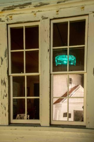 reflection of the lighthouse in the keeper's cottage window
