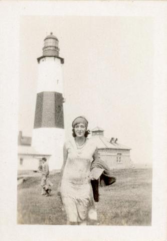 woman poses in front of tower
