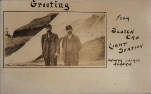 keepers pose with lighthouse in distance