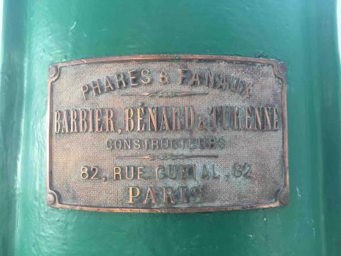 brass nameplate on lens pedestal