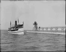 large ship passes tower