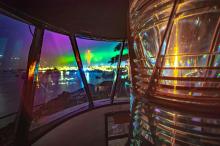 Fresnel lens in lantern with aurora in sky