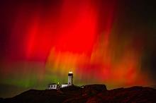 Aurora borealis behind the lighthouse