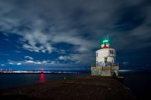 cityscape behind lighthouse