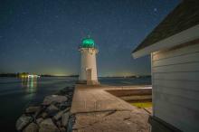 lighthouse at night under the stars