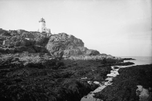 fog bell tower in front of lighthouse
