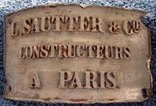 Company badge from Fresnel lens pedestal 